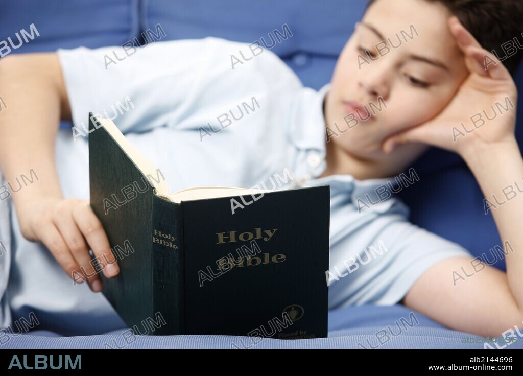 Boy reading Bible.