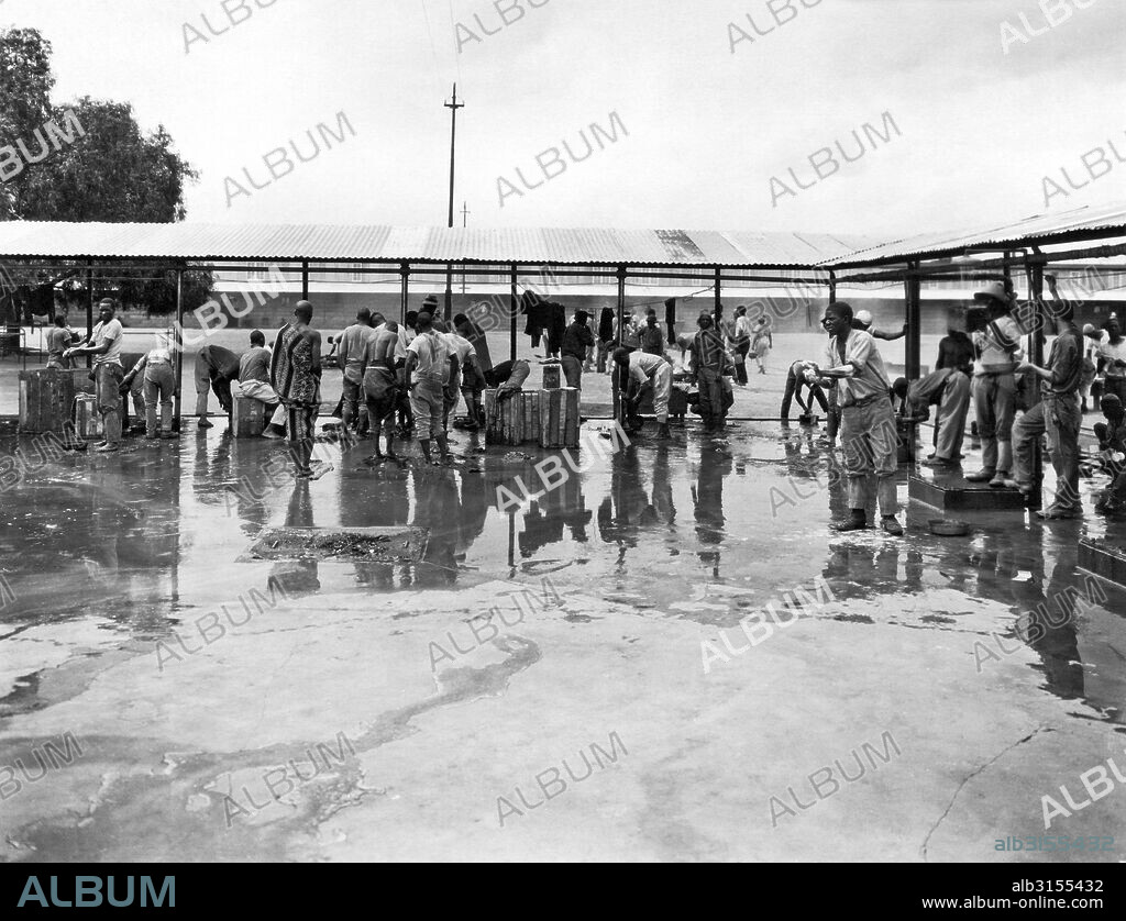 Kimberley, South Africa:  c. 1920 A scene in the native compound where the native workers are treated almost like prisoners. The men work in the mines all day, and at night they are guarded in the walled compound to try to keep any of the diamonds from being stolen.