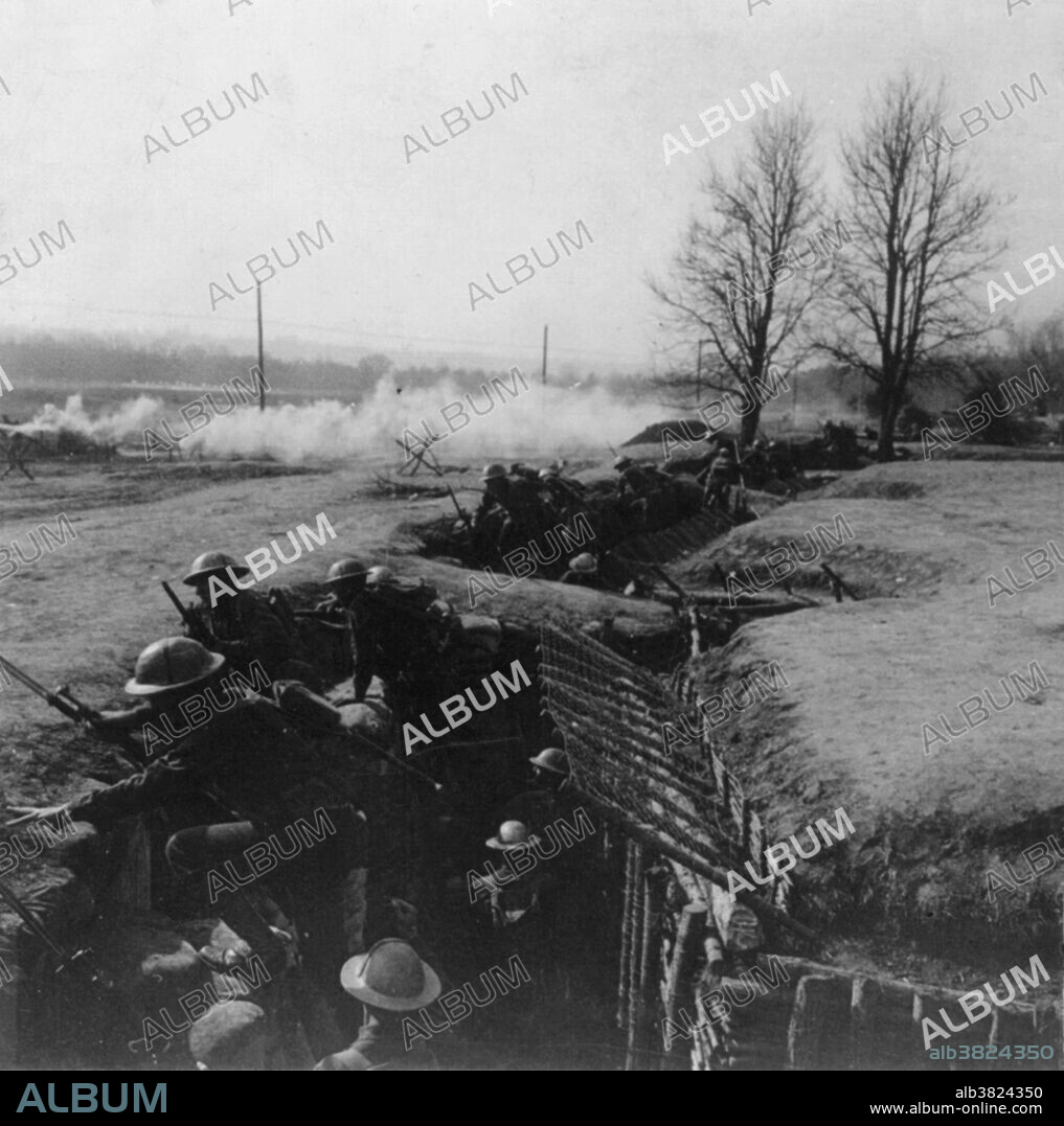 American soldiers in trench answering the bugle call to charge during World War I. Trench warfare is a form of land warfare using occupied fighting lines consisting largely of trenches, in which troops are significantly protected from the enemy's small arms fire and are substantially sheltered from artillery. The most prominent case of trench warfare is the Western Front in World War I. Both sides constructed elaborate trench and dugout systems opposing each other along a front, protected from assault by barbed wire. The area between opposing trench lines (no man's land) was fully exposed to artillery fire from both sides. Attacks, even if successful, often sustained severe casualties. The common infantry soldier had only a few weapons to use in the trenches: the rifle, bayonet, and hand grenade. No location given on caption card.