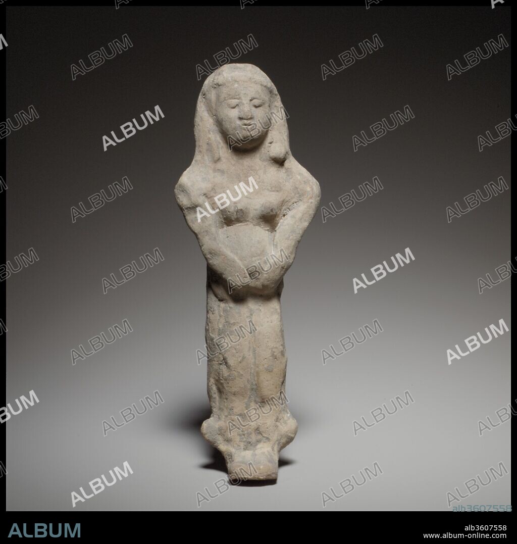 Standing female figurine. Culture: Cypriot. Dimensions: H. 6 3/4 in. (17.1 cm). Date: end of the 6th century B.C..
The figurine is mold-made, solid, and flat at the back. Her arms and belly were reworked by hand.