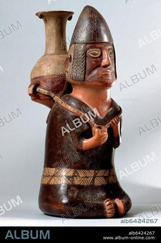 An effigy ceramic showing a male figure carrying the Inca aryballus on his back. In his hand is a small container, possibly for coca leaves. Country of Origin: Peru. Culture: Inca. Date/Period: 1430-1.