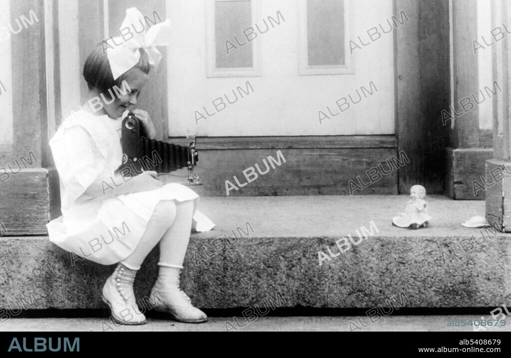 Editorial use only . Young girl taking a Kodak picture of her doll. Kodak was founded by George Eastman and Henry A. Strong on September 4, 1888. During most of the 20th century, Kodak held a dominant position in photographic film. The company's ubiquity was such that its Kodak moment tagline entered the common lexicon to describe a personal event that was demanded to be recorded for posterity. An amateur photographer may take photographs for pleasure and to record an event, emotion, place, as a person without a monetary motivation. An amateur may make considerable sums entering work in contests for prize money or through occasional inclusion of their work in magazines or the archive of a photo agency. H. T. Mitchell, May 24, 1917.