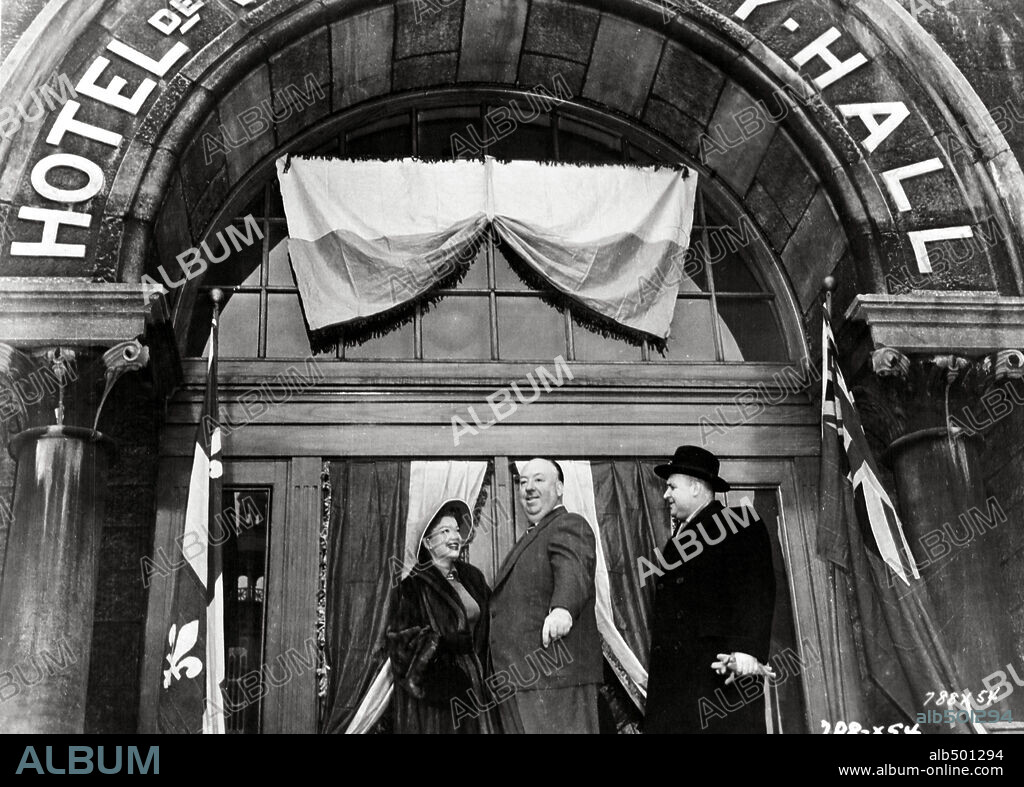 ALFRED HITCHCOCK and ANNE BAXTER in I CONFESS, 1953, directed by ALFRED HITCHCOCK. Copyright WARNER BROTHERS.