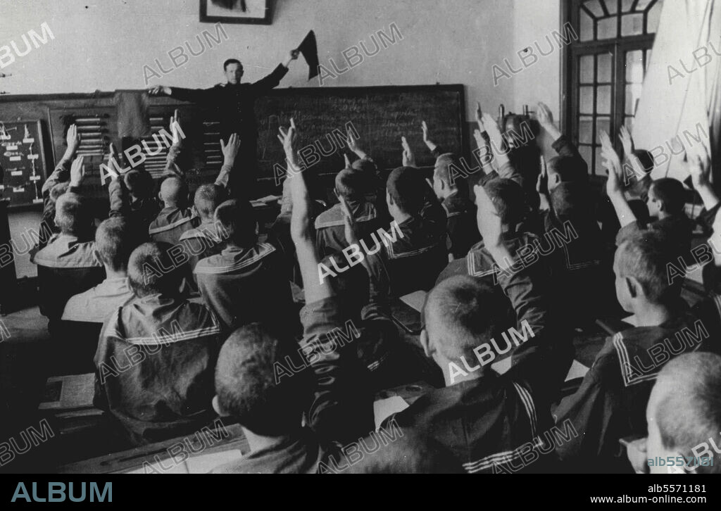 Russian Naval College Had Two Heroes -- One Aged 13 -- With the lengths of rope fixed to boards on the wall, a model sailing-cutter, and a binnacle in one corner, it is an exact replies of a Royal Navy seamanship school. Here young cadets at the Wahimov College receive a lesson in semaphore - letter "Q" at the dip! Soviet equivalent of Britain's Darmouth, the Wahimov College in Leningrad, training-ground for cadets who will eventually become officers in the Russian Navy, has two heroes. The first is Captain Izatchek, much-decorated hero of World War 1. Director of the College, he is responsible for the cadets from the time they enter until they leave, six years later, to join the Navy. September 3, 1951. (Photo by Mirror Features).