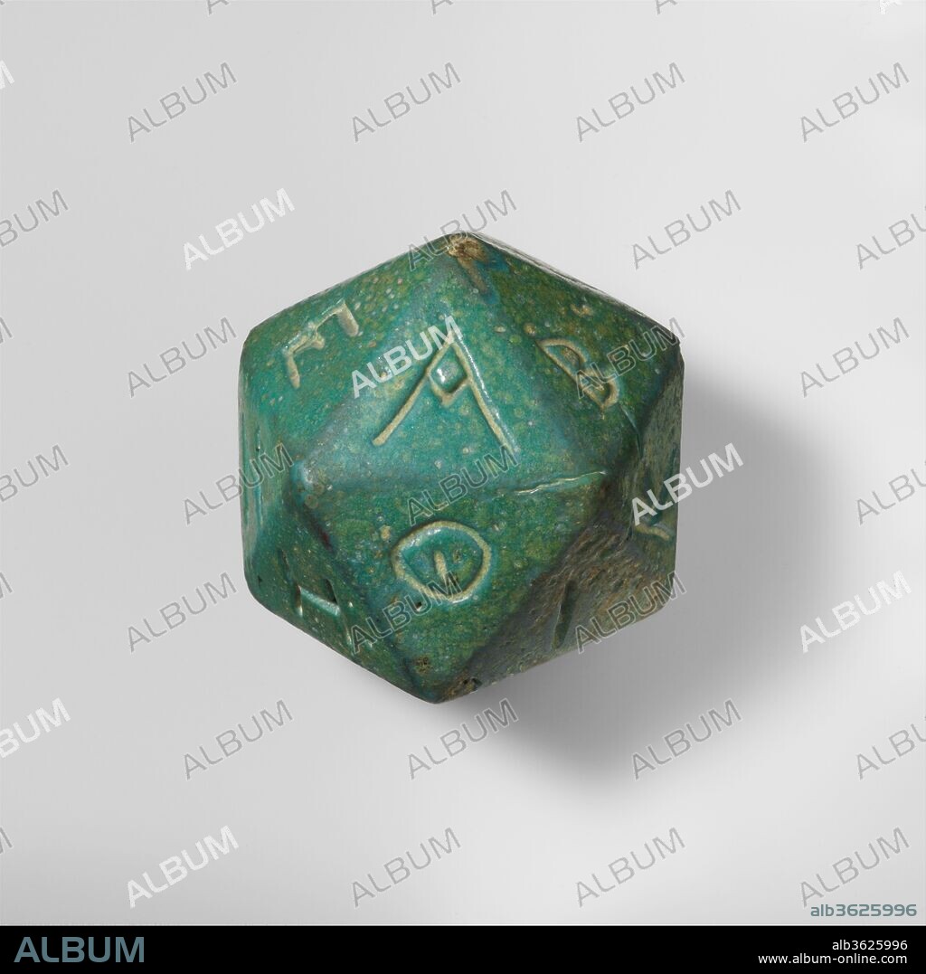 Faience polyhedron inscribed with letters of the Greek alphabet. Culture: Roman. Dimensions: Width (Point to point, greatest): 2 11/16 in., 7.2oz. (6.8 cm, 204.9g)
Width (Point to point ,smallest): 2 1/2 in. (6.3 cm)
Width (Side to side, greatest): 2 3/16 in. (5.6 cm)
Width (Side to side, smallest): 2 3/16 in. (5.5 cm). Date: 2nd-3rd century A.D..
A number of polyhedra made in various materials are known from the Hellenistic and Roman periods. They may have been used in conjunction with an oracle inscribed on a pillar set up in a public place. The polyhedron was thrown in order to choose a letter at random. One consulted the inscription to find the matching letter and read the oracle's response. There would be twenty oracular messages, each beginning with a letter of the alphabet that corresponded to one side of the dice.