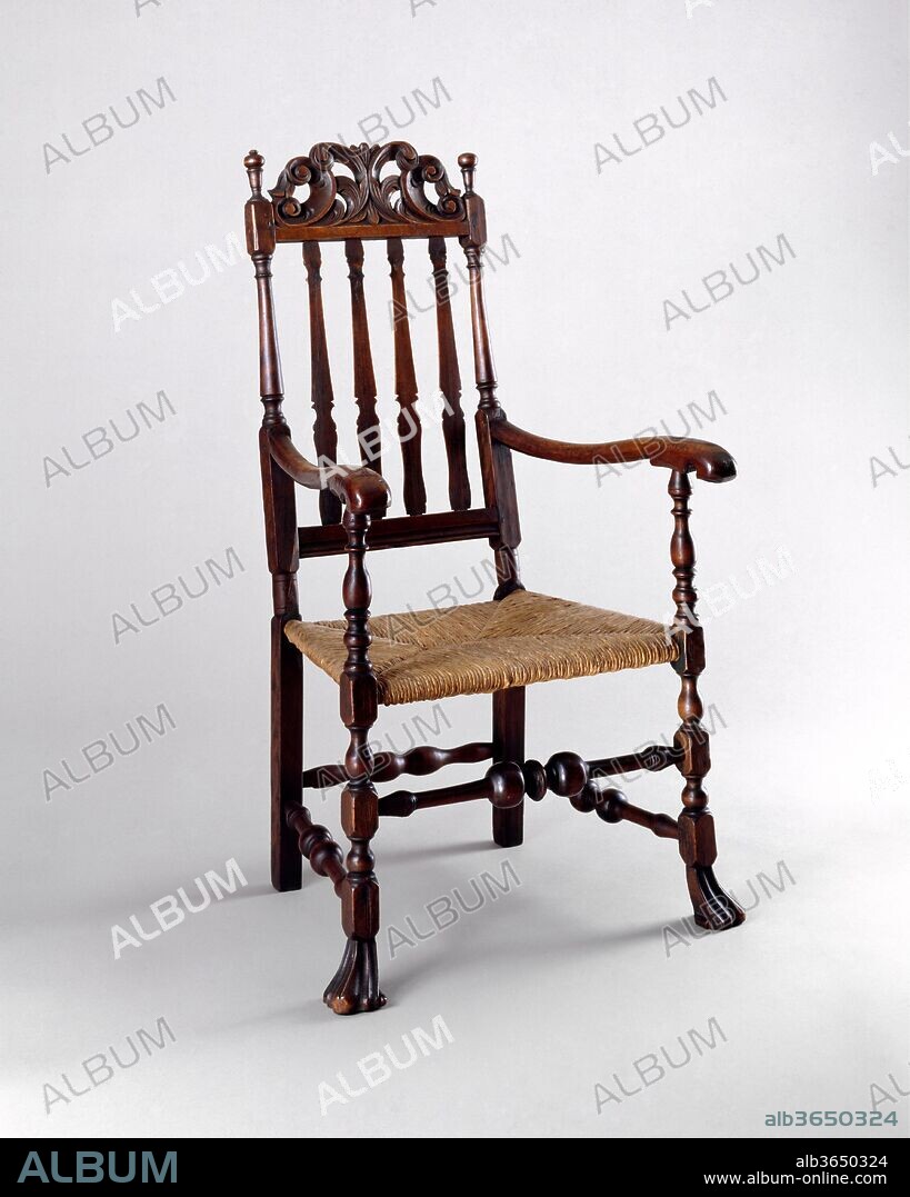 Banister-back armchair. Culture: American. Dimensions: 44 1/2 x 23 x 22 1/2 in. (113 x 58.4 x 57.2 cm). Date: 1720-40.
The carved crest rails on top of tall-back William and Mary-style chairs imparted an aura of importance to the sitter by providing a background of flourishes. The large scale and verve of the carving on this chair, with its stylized central leafage and play of repeating C-scrolls, are particularly effective.