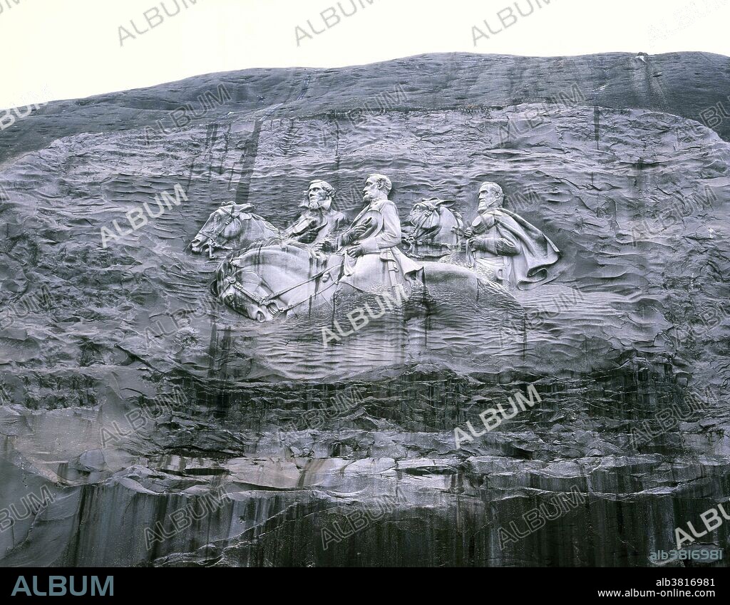 Stone Mountain Confederate Memorial Carving, Georgia. This is the largest low relief sculpture in the world, depicting Robert E. Lee, Jefferson Davis and an unknown soldier. The carved surface is three acres in size and was completed in 1972 by chief carver Roy Faulkner. It is a patriotic tribute to the soldiers of the Confederacy. It is also associated with the Klu Klux Klan, since the second incarnation of the clan was formed on Stone Mountain.