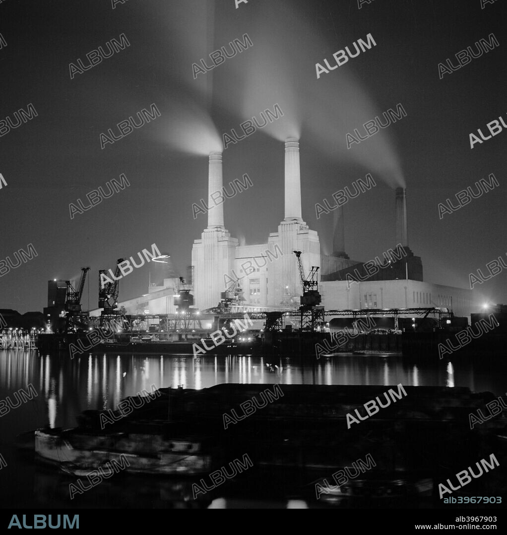 Battersea Power Station, London, 1945-1980. View from the north bank of the Thames. It was designed in 1937 by Sir Giles Gilbert Scott (1880-1960) and was the largest brick building in Europe.