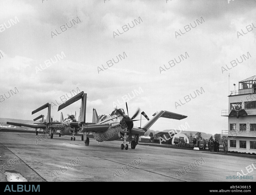 Inauguration Service For Navy's First Flight Of Gannet Aircraft. The Fairey Gannets seen, upon landing after the Fly Past during today's "Hand Over" Ceremony, collapsing their wings as they taxi past the saluting base at the R.N, Air Station at Ford (Sussex). The Royal Navy's first unit of Fairey Gannet anti-submarine aircraft was formally inaugurated at the R.N. Air Station at Ford, Sussex today. The Garnet, a super-priority plane, is the first aircraft to be designed solely for anti-submarine.