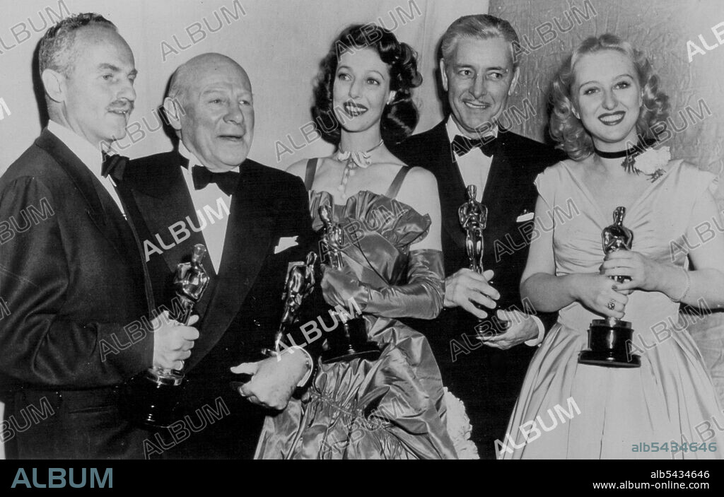 Here Are Winners in Hollywood's Oscar Derby - Proudly holding their gold Oscars are the five principal winners in last night's Academy Award presentations. Left to right: Darryl Zanuck, producer of the best picture, "Gentleman's Agreement"; Edmund Gwenn, best supporting actor; Loretta Young, best actress; Ronald Coleman, best actor; and Celeste Holm best supporting actress. March 21, 1948. (Photo by AP Wirephoto).