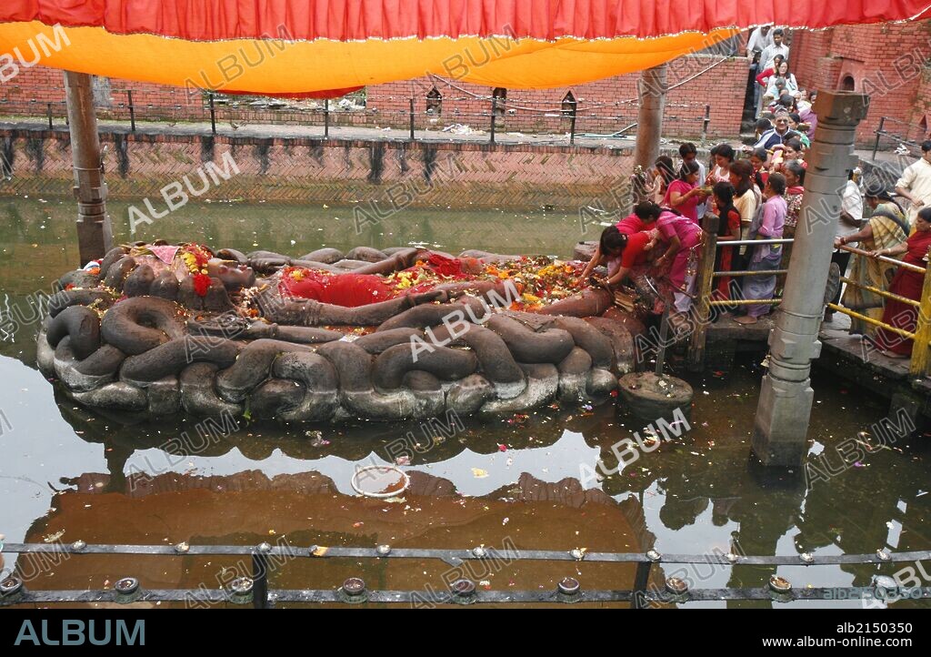 Vishnu lying on a Naja snake bed at Buddha Nilkantha shrine.