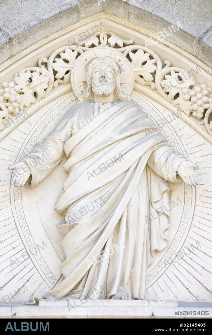 Christ sculpture on church tympanum.