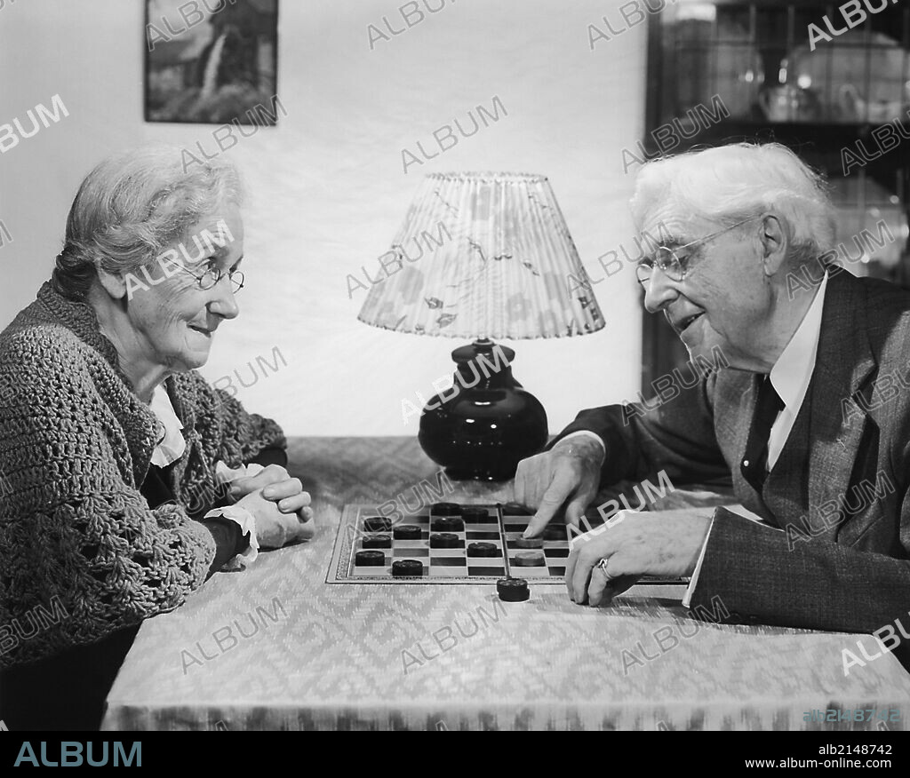 Photo album with black-and-white picture of senior couple. Photos